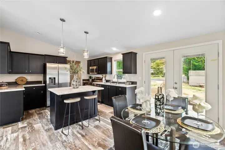 Dining and kitchen with bar and appliances