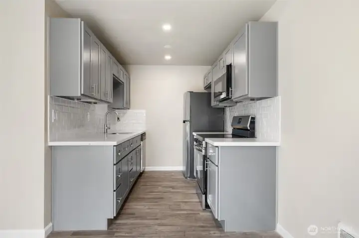 Fully renovated kitchen with new SS appliances, countertops and cabinetry.