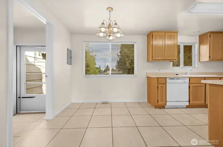 Dining area adjacent to kitchen with access to patio and backyard.