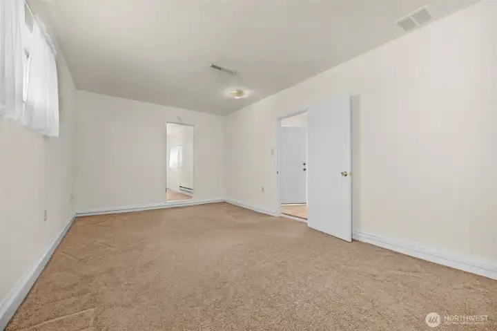 View of family room from side entry showing access to 3rd bedroom.