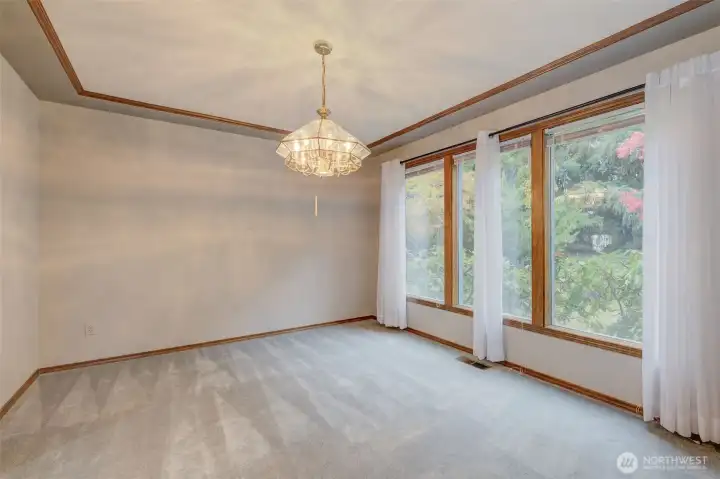 Spacious dining room with custom wood tray ceiling and its own access to the covered side porch!