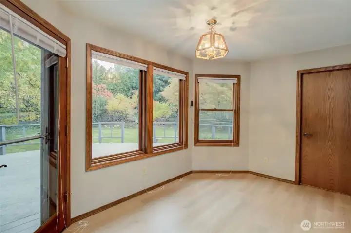 Breakfast room leads to the rear deck. Enjoy the LVP floors and windows to drink in your scenery rain or shine!