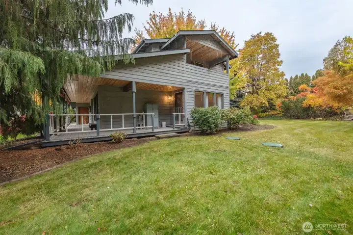 This view from the side shows the generous covered porch and the upstairs covered balcony!