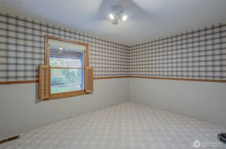This main-floor bedroom has style and a wall-to-wall closet! (not shown)