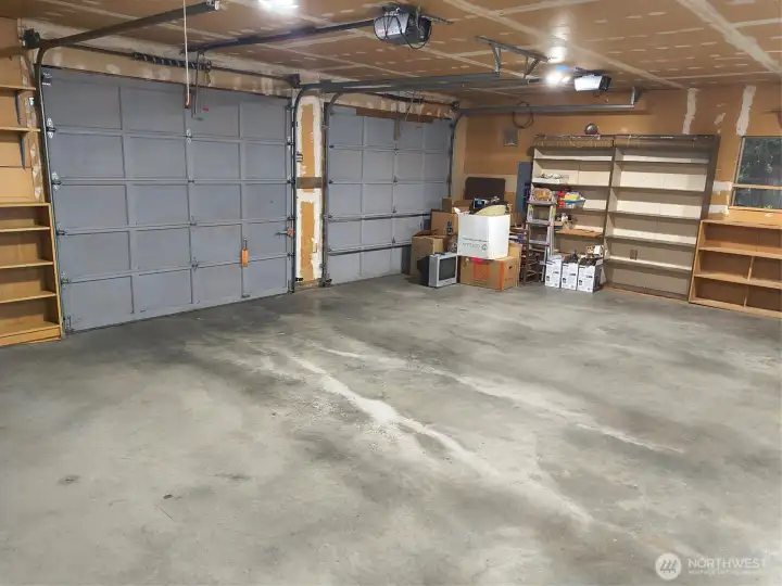 Attached garage is EXPANSIVE and includes wall-to-wall storage areas, workshop and extra appliances.