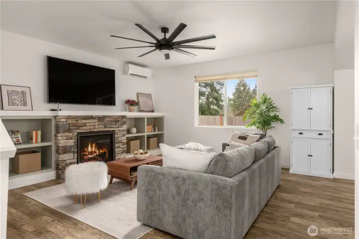 Spacious family room featuring a striking oversized fan and a cozy gas fireplace, perfect for warmth and style.