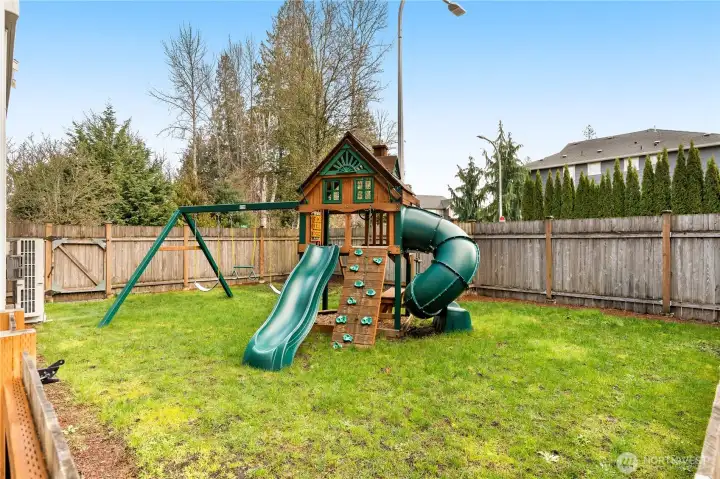 A fully fenced play area with a play structure offers a safe space for kids to explore, climb, and enjoy outdoor fun!