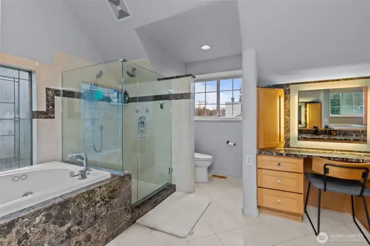 Primary bath with soaking tub, shower, vanity desk, double sink and access to large closet