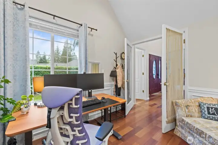 Middle level bedroom/office, equipped with French doors, and immediately next to a powder room.