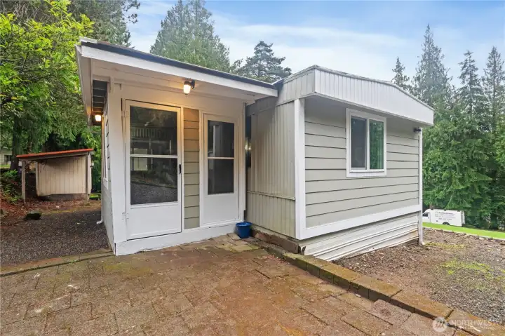 Covered entry and deck area offering additional outdoor living space. Covered entry and deck area offering additional outdoor living space.