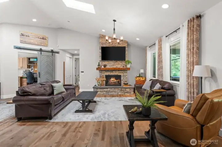 Spacious great room with a floor-to-ceiling stone fireplace and an open layout that connects seamlessly to the surrounding living areas.