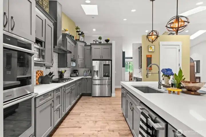 Custom cabinetry, quartz countertops, and a gas cooktop combine style and functionality throughout the kitchen.