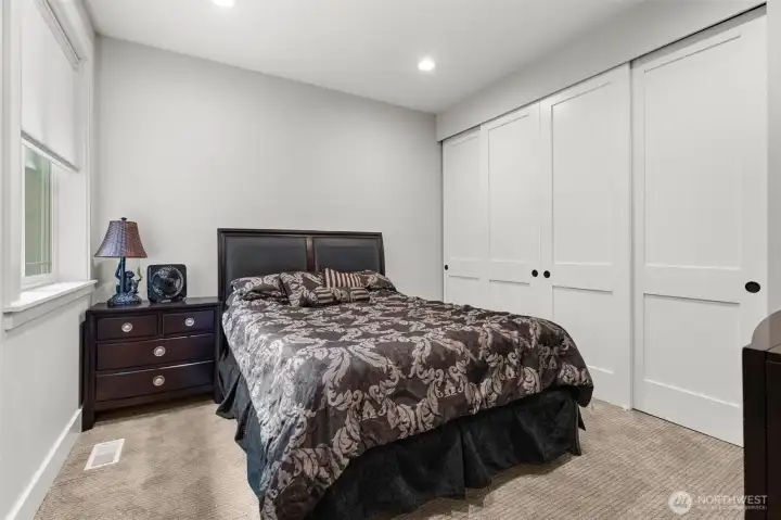 Well-sized bedroom includes a large closet, carpeted flooring, and space for a variety of furniture arrangements.