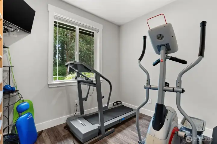 Bonus room features a bright window and adaptable layout to accommodate a variety of uses.