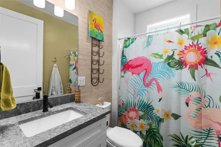 Well-appointed full bathroom offers a spacious vanity, tub/shower combination, and natural light from the window.
