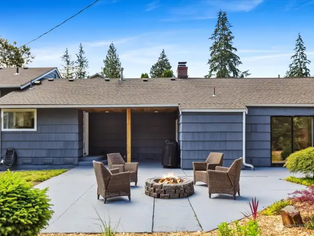 Entertainment-sized back patio with firepit.