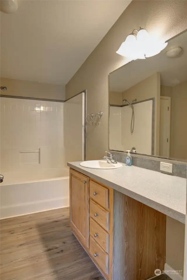 Primary bath with vanity seating area.