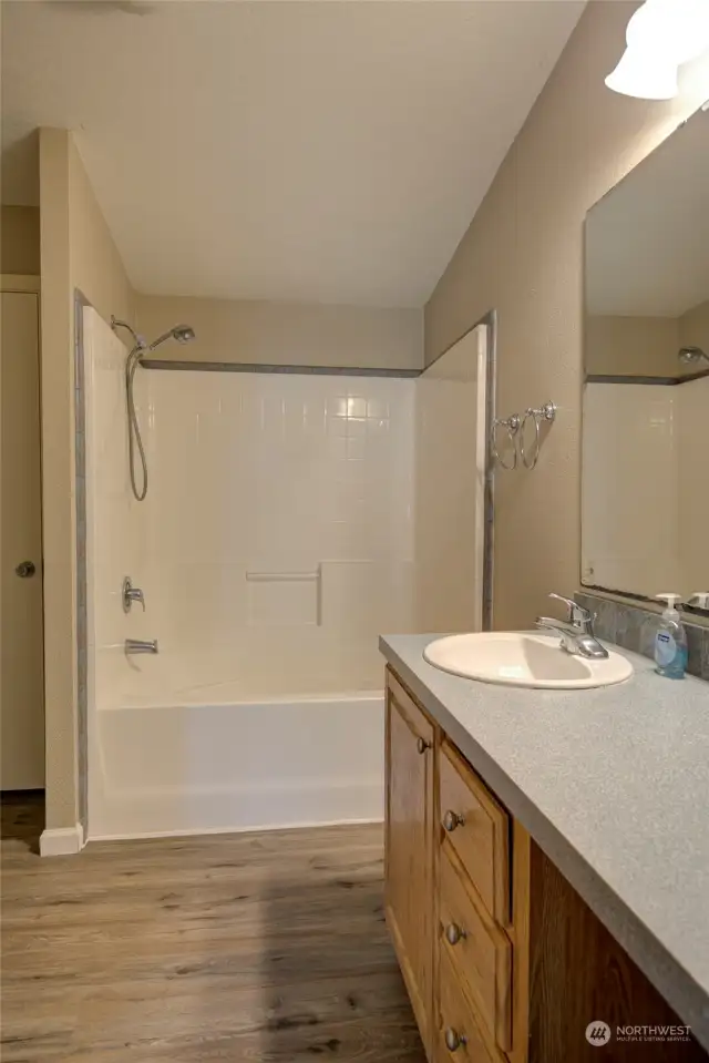 Large soaking tub/shower combo in primary bath.