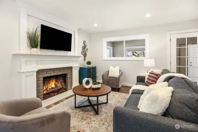 Cozy living room offers additional space to hang out around the gas fireplace.