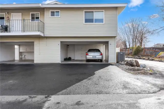 Covered Carport parking w/ deep storage cupboards & closet