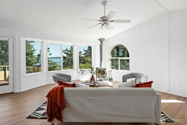 Large living room with expansive views and a wood stove to keep you cozy warm in the winter!
