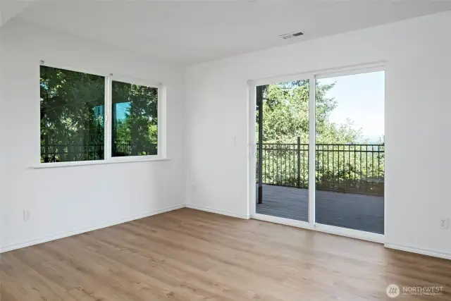 Dining space in the downstairs living quarters offers easy access to the expansive lower deck to enjoy the water views!
