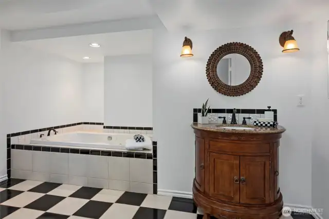 Lower level guest bathroom features a huge jetted soaking tub.