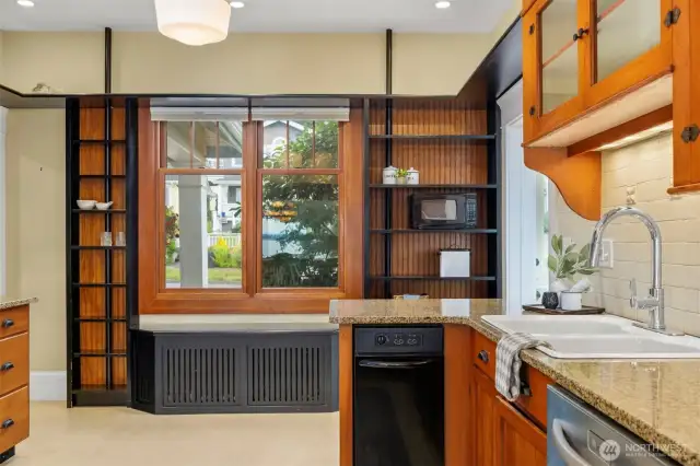 Kitchen details, beverage fridge, modern trash compactor, custom cabinets, convenient pantry. There is space for a couple of people to cook and create tasty meals.
