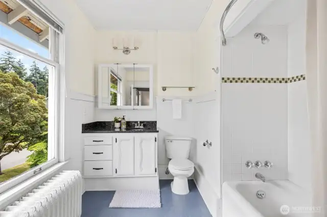 Updated bathroom with original bathtub.