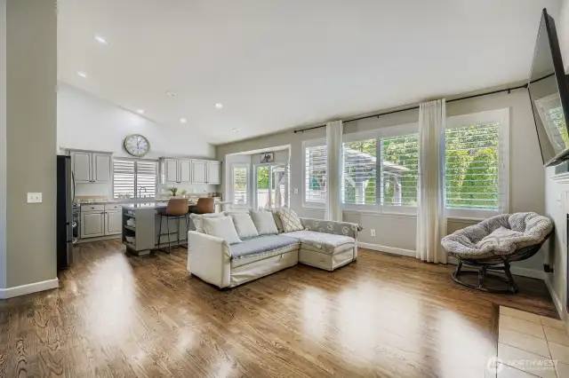 Large open concept kitchen, living/dining with an abundance of natural light