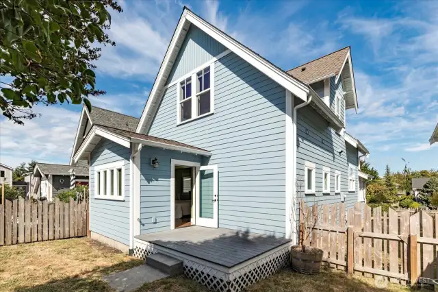 Backyard with composite decking and space for gardens.