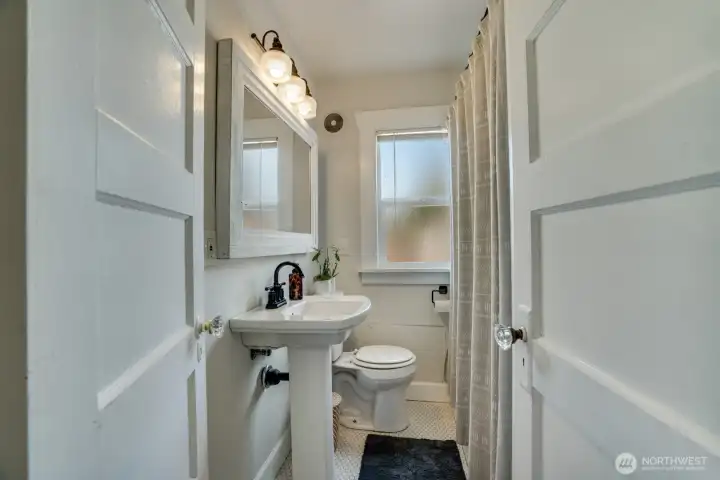 Fully upgraded bathroom on the main floor. New tile tub surround, lighting and timeless penny round floors