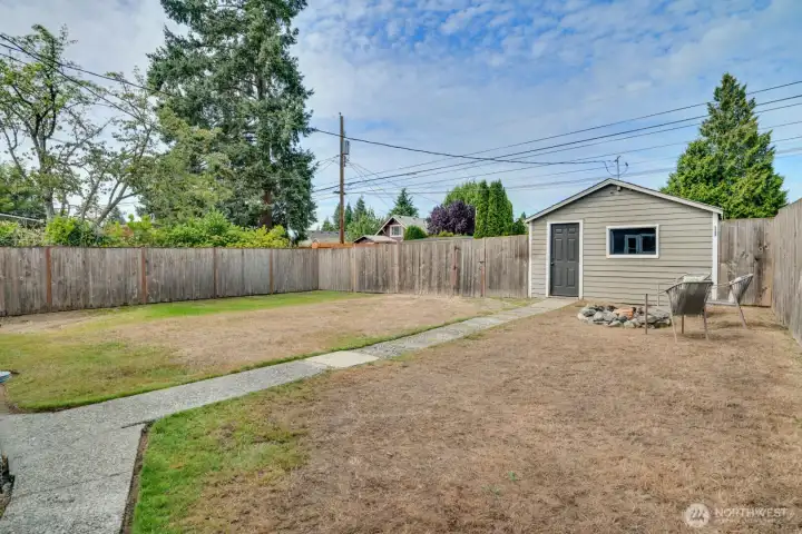 Large fully fenced backyard! To the left of the garage, there is a gravel parking space. Expand this garage and/or built your detached ADU. Alley access makes way for many possibilities.