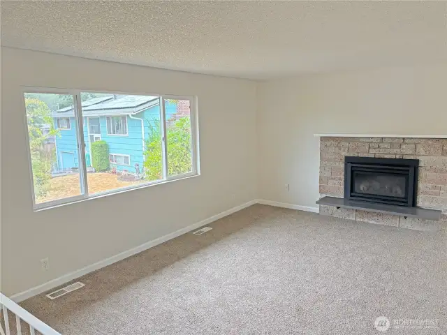 Living room at 16312 127th Pl SE, Renton—thoroughly updated split-level, 1,730 sf; comfortable main-level gathering space near amenities in the Cascade neighborhood.