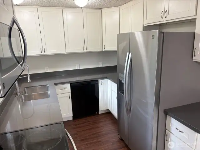Closer kitchen view showcasing the stainless-steel appliance package and clean, refreshed finishes—updated split-level home in Renton’s Cascade neighborhood 98058.