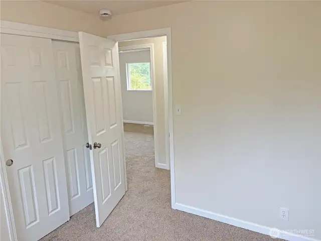 Bedroom #1 in the updated split-level at 16312 127th Pl SE, Renton—bright space with fresh paint, new flooring, and closet storage; flexible for sleeping or a home office in the Cascade neighborhood 98058.