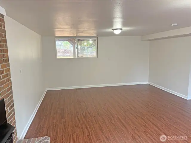 Alternate view of the basement family room in this split-level home—bright, refreshed finishes and room to relax or play in Renton’s Cascade neighborhood.
