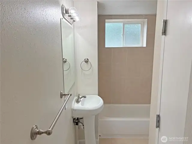 Basement full bathroom in the fully finished lower level at 16312 127th Pl SE, Renton—updated, clean finishes; convenient to family room and flex space in Cascade 98058.