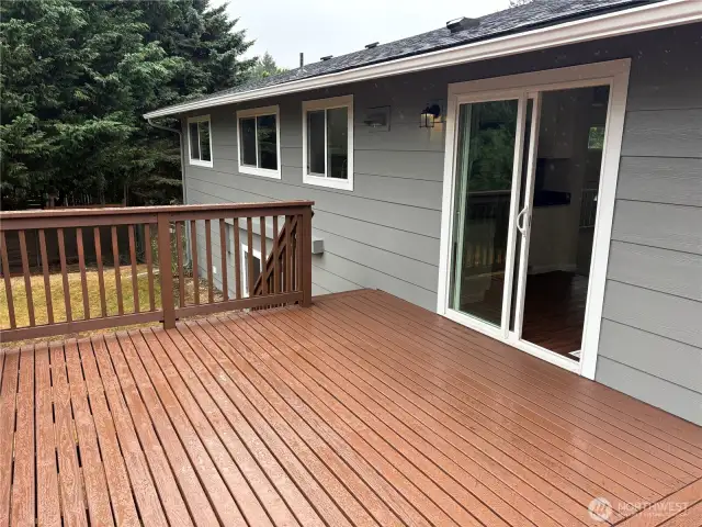 Large rear deck overlooking the expansive backyard and giant apple tree—outdoor living space off the main level at 16312 127th Pl SE, Renton (Cascade 98058).
