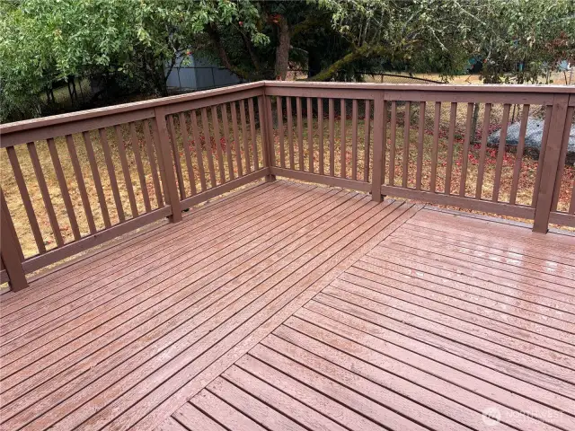 Alternate view of the spacious deck with railings and steps to the wide lawn and garden shed—updated split-level in Renton’s Cascade neighborhood 98058.
