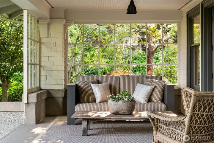 The front porch opens wide to the formal living room where  a frame television is equally at home with sports as it is with powerpoint presentations.