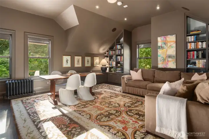Media room with refrigerator, vaulted ceilings, builtins and space for fun and games.