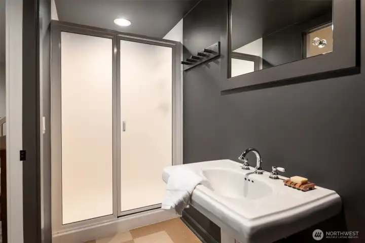 Convenient bathroom with easy access to outdoor spaces, gym, and second laundry room.