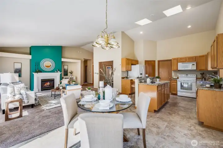 The great room layout connects the kitchen, cozy breakfast nook, and inviting living room in one flowing space.