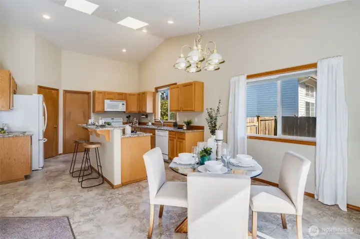 The kitchen features high ceilings and skylights.