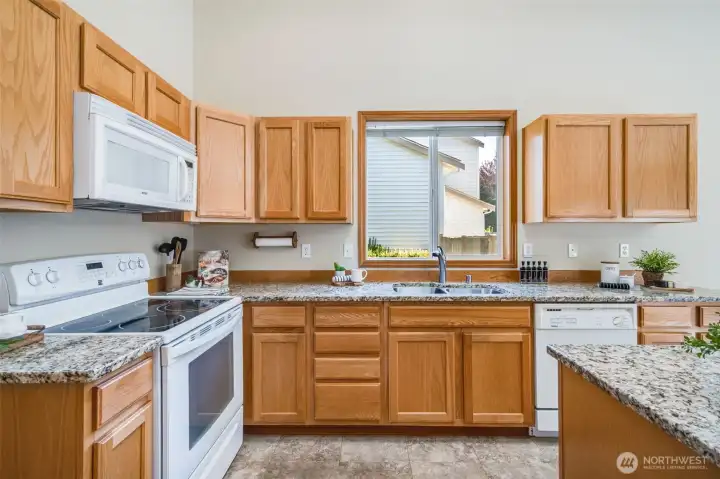 Beautiful granite countertops offer a sleek and durable workspace in the heart of the home.