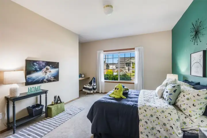 The second bedroom looks out over the front yard. Carpets make it cozy!