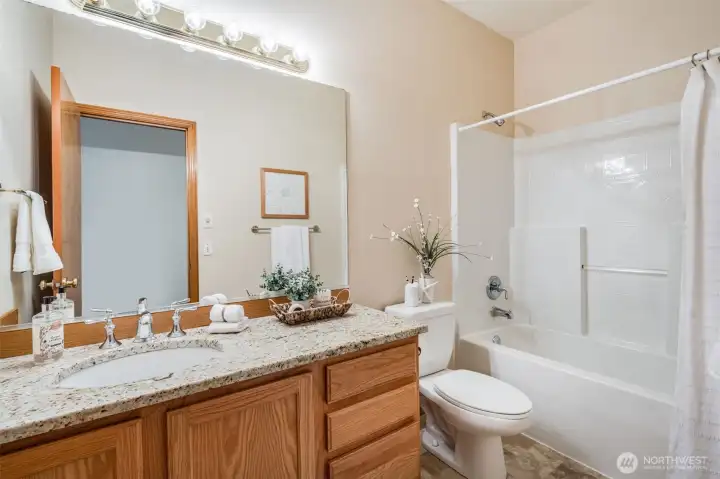 The guest bathroom is located near bedrooms and the living room.