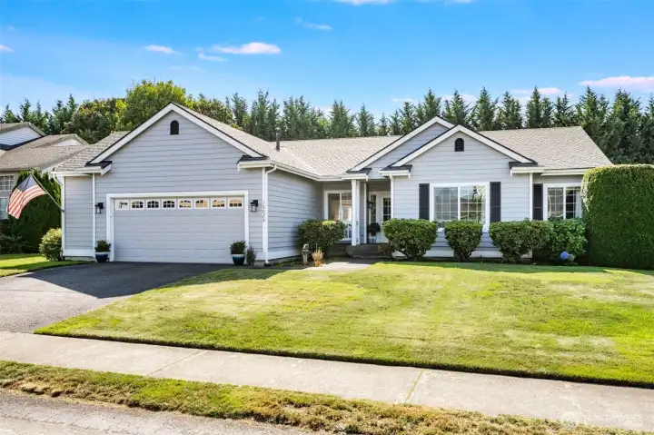 Beautifully maintained front yard with mature plants and lush greenery.