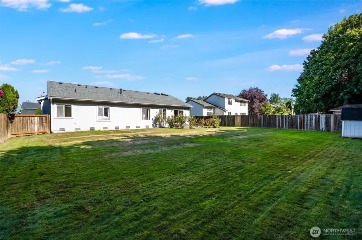 The spacious backyard is perfect for relaxing, playing, or entertaining outdoors.